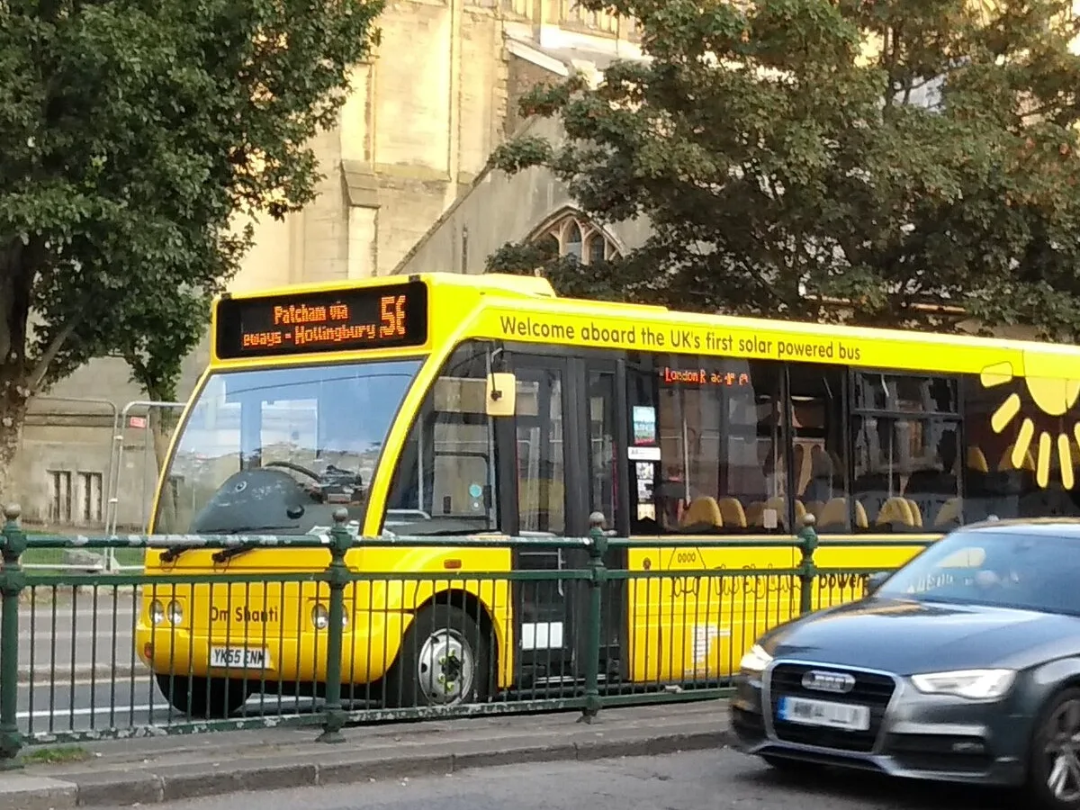 The bright yellow Big Lemon bus Om Shanti with the slogan Welcome aboard the UK's first solar powered bus