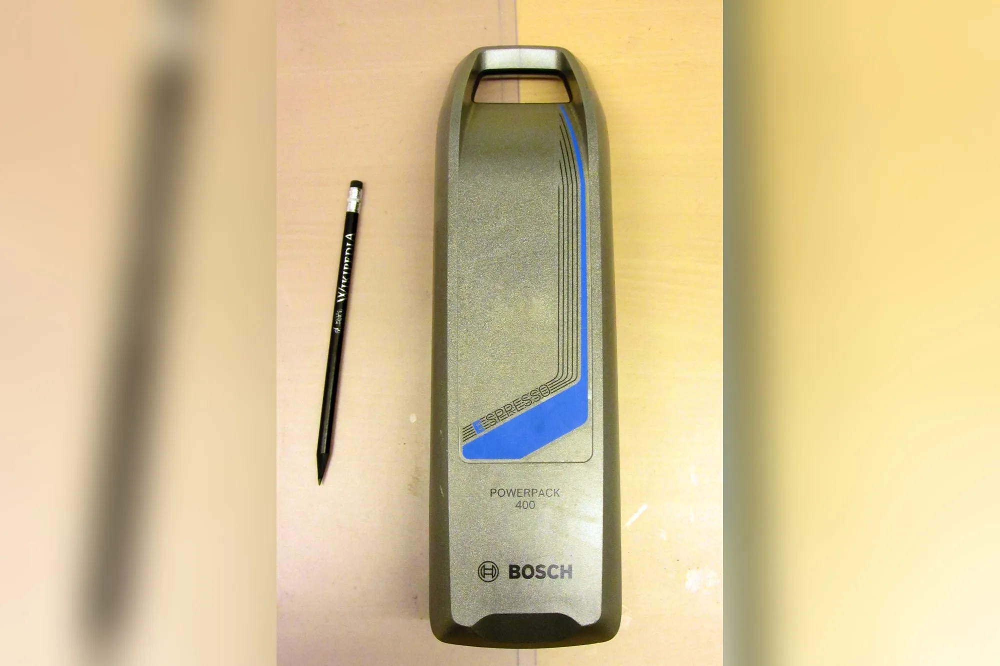 Removable Bosch PowerPack 400 e-bike battery next to a pencil
