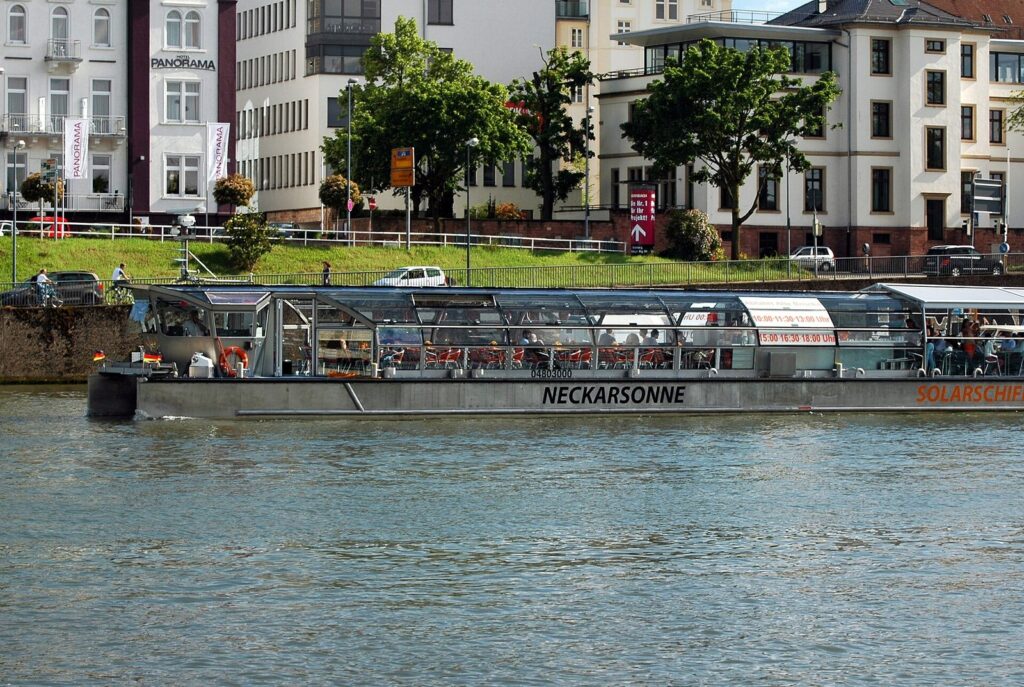Passengers on board the Neckarsonne in front of Heidelberg's old town.