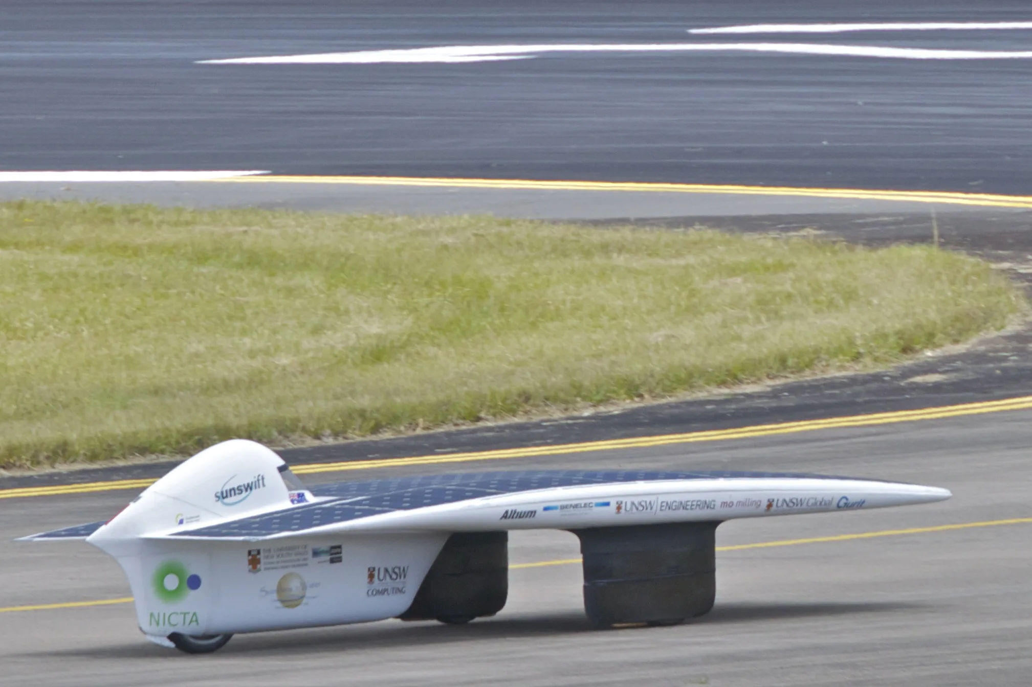 The three-wheeled Sunswift IVy solar race car on the runway at HMAS Albatross during its speed record