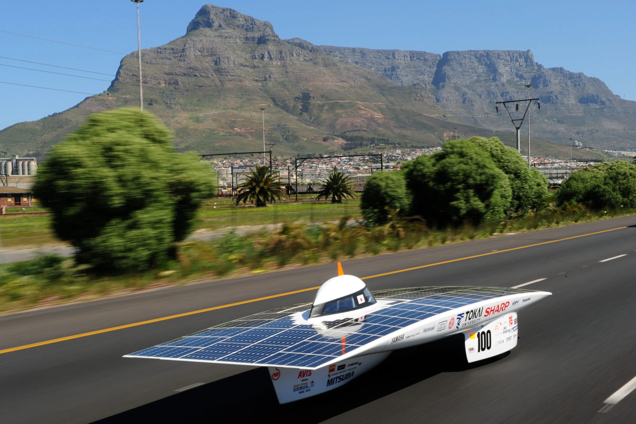 The flat Tokai Challenger solar race car on a road with Table Mountain in the background, South Africa 2010