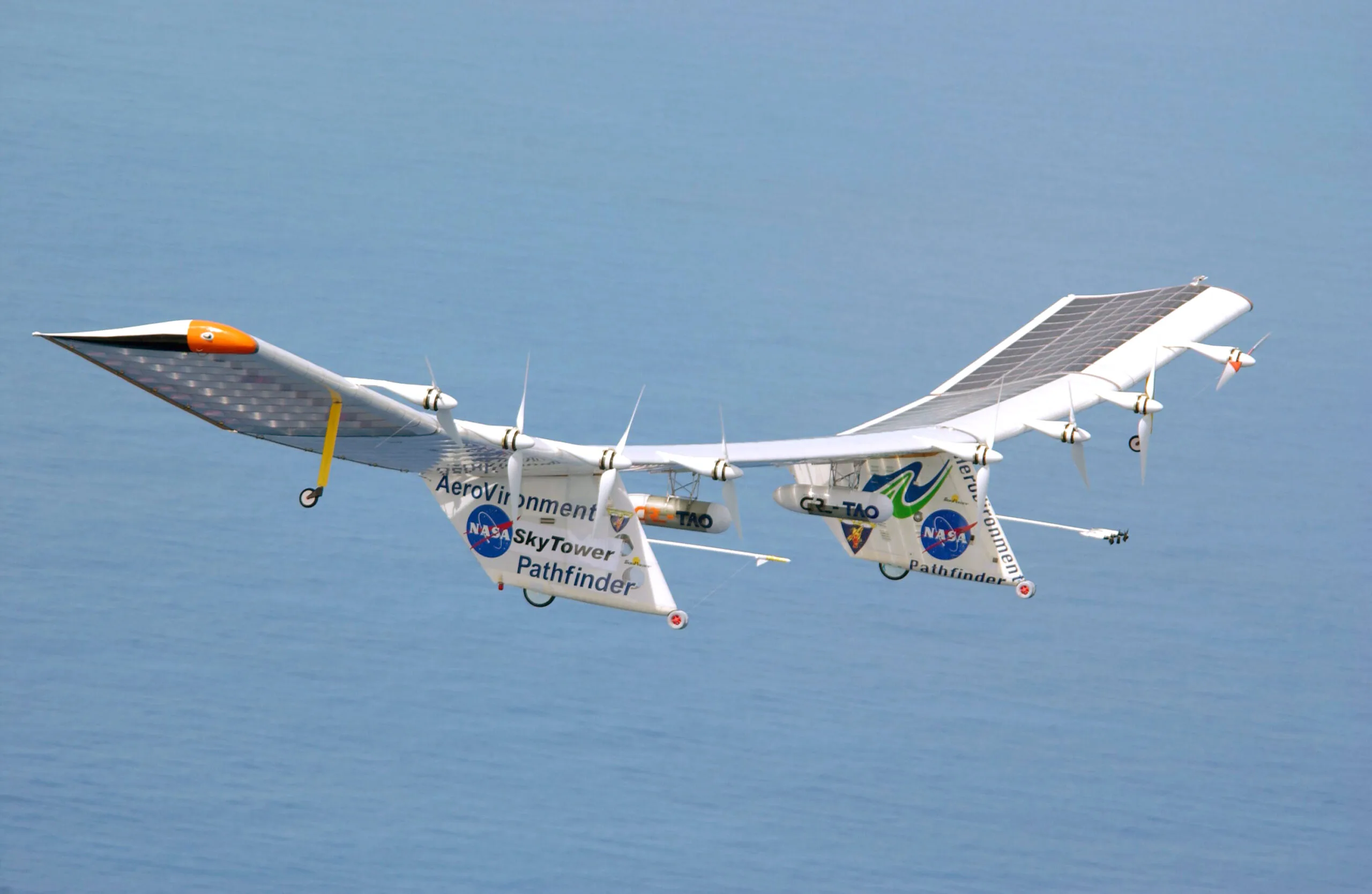 NASA's Pathfinder-Plus solar flying wing with its row of propellers flying over Hawaii