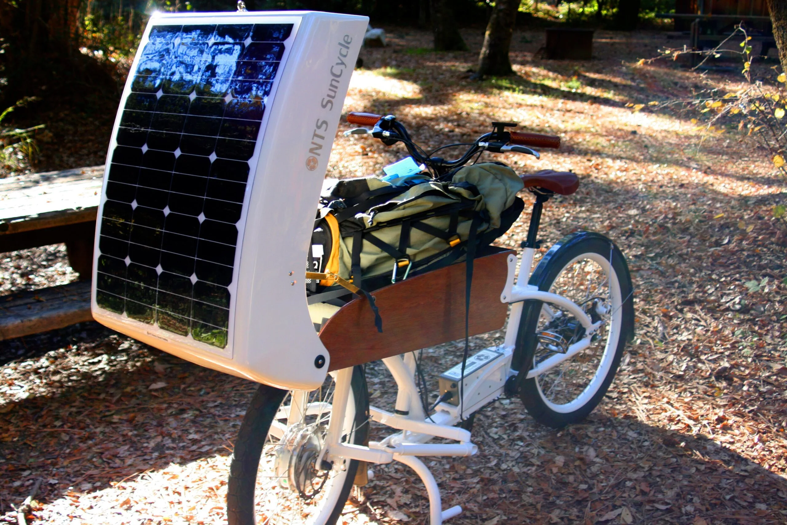 NTS SunCycle cargo bike with a 60 watt solar panel on the lid of its front cargo box