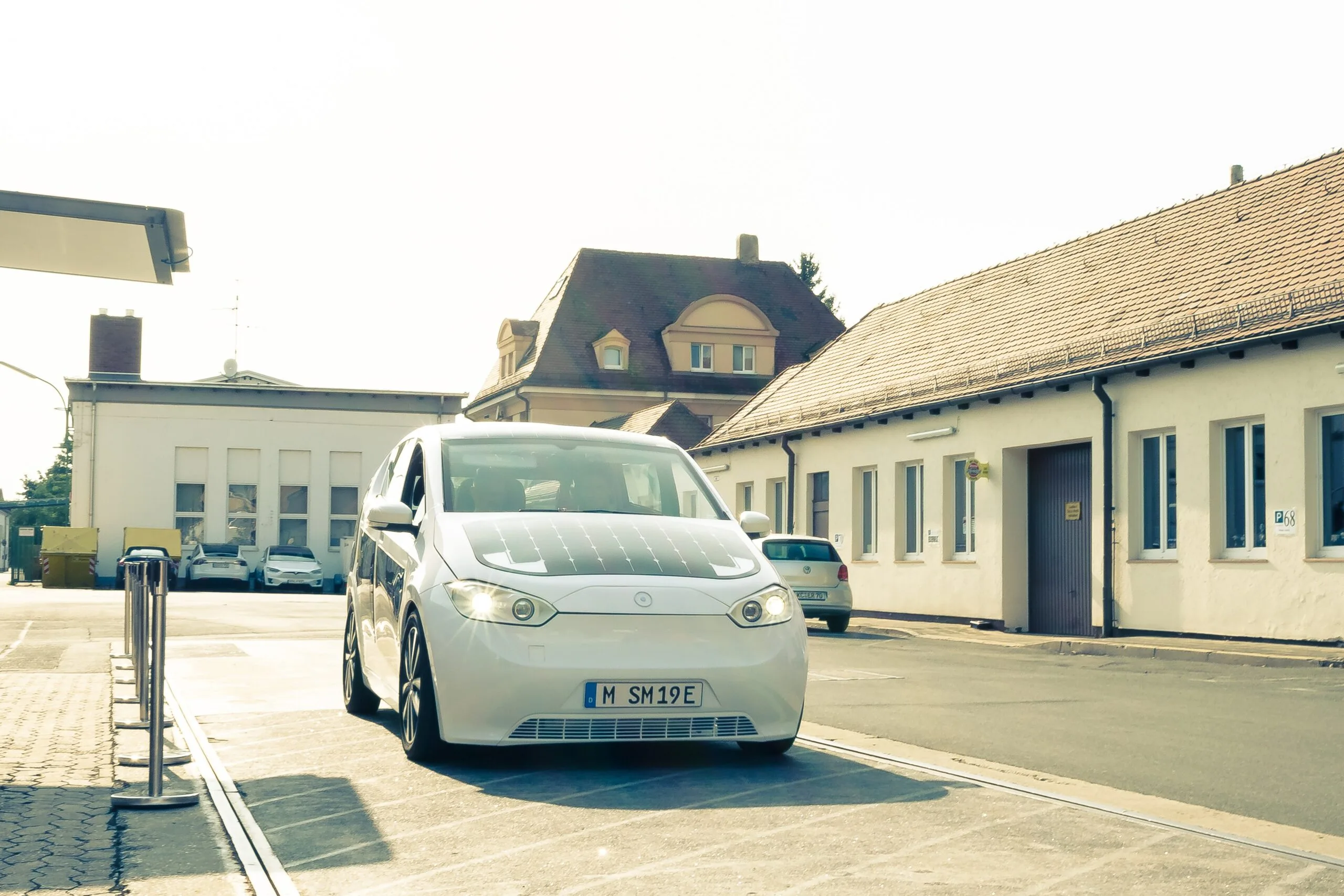 White Sono Sion solar electric car prototype parked on a street in Nuremberg